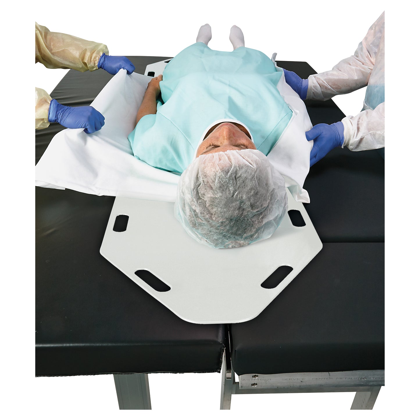 A patient on the AliMed Anti-Stat Patient Shifter is being moved by two people wearing protective clothing and gloves.