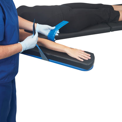 A person secures an arm with an AliMed AliBlue Gel Armboard Strap, designed for comfortable positioning on an armboard.