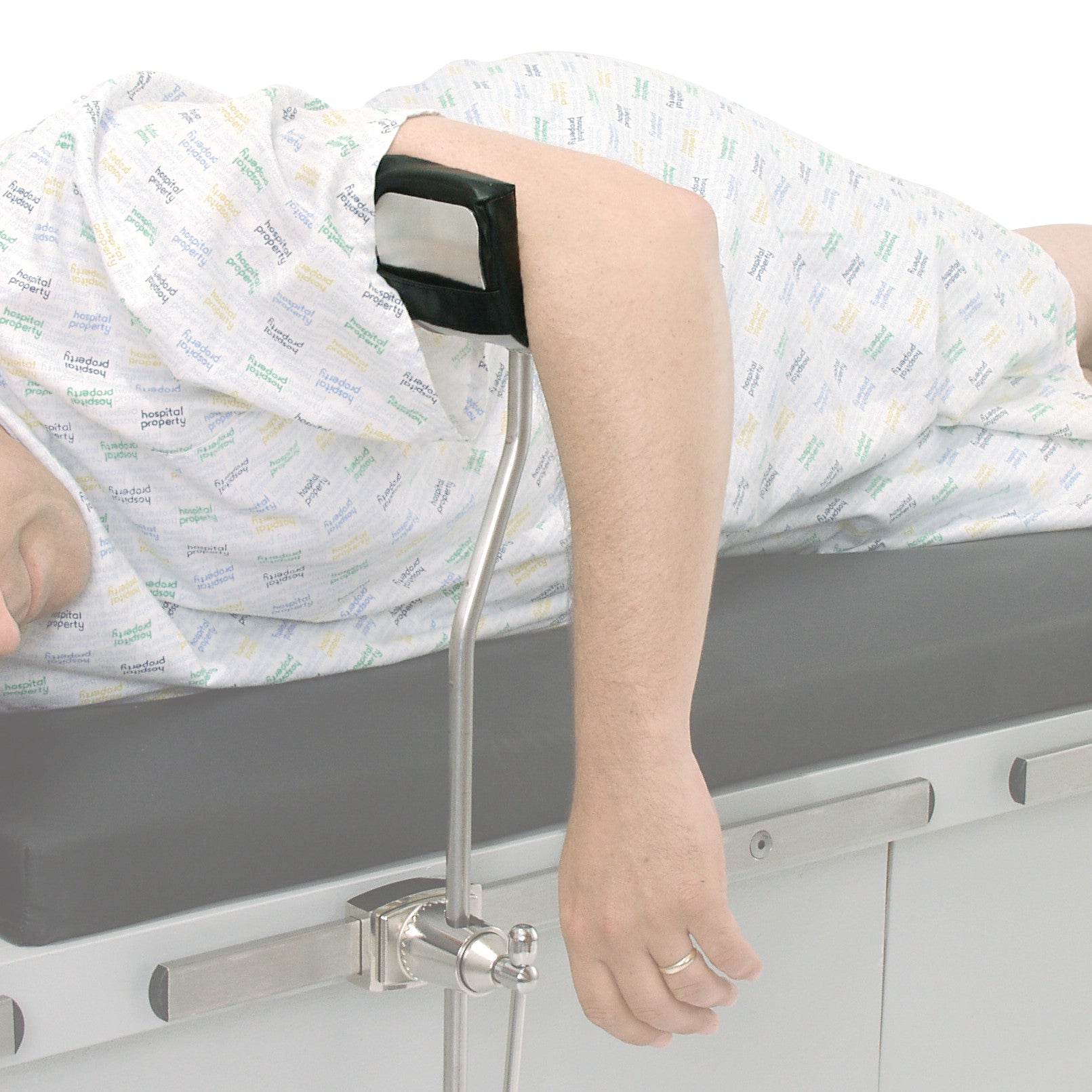 Person lying on a medical table using a Replacement Pad for AliMed Elbow Arthroscopy Positioner to support their arm.