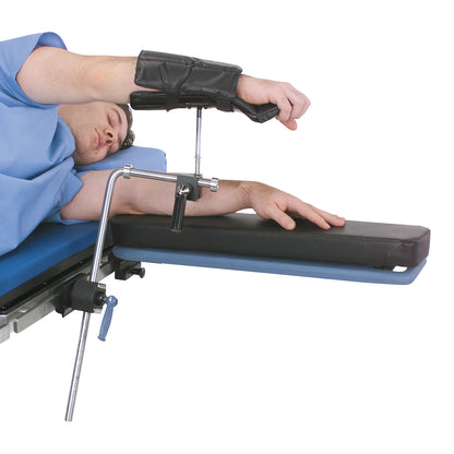 A person using the Replacement Pad for Allen Lateral and Prone Arm Support, which is attached to a medical table.