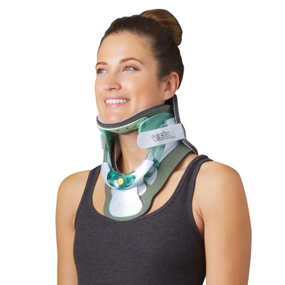 A woman wearing an Aspen Vista TX Cervical Collar Set, smiling and looking upward while dressed in a dark sleeveless top.