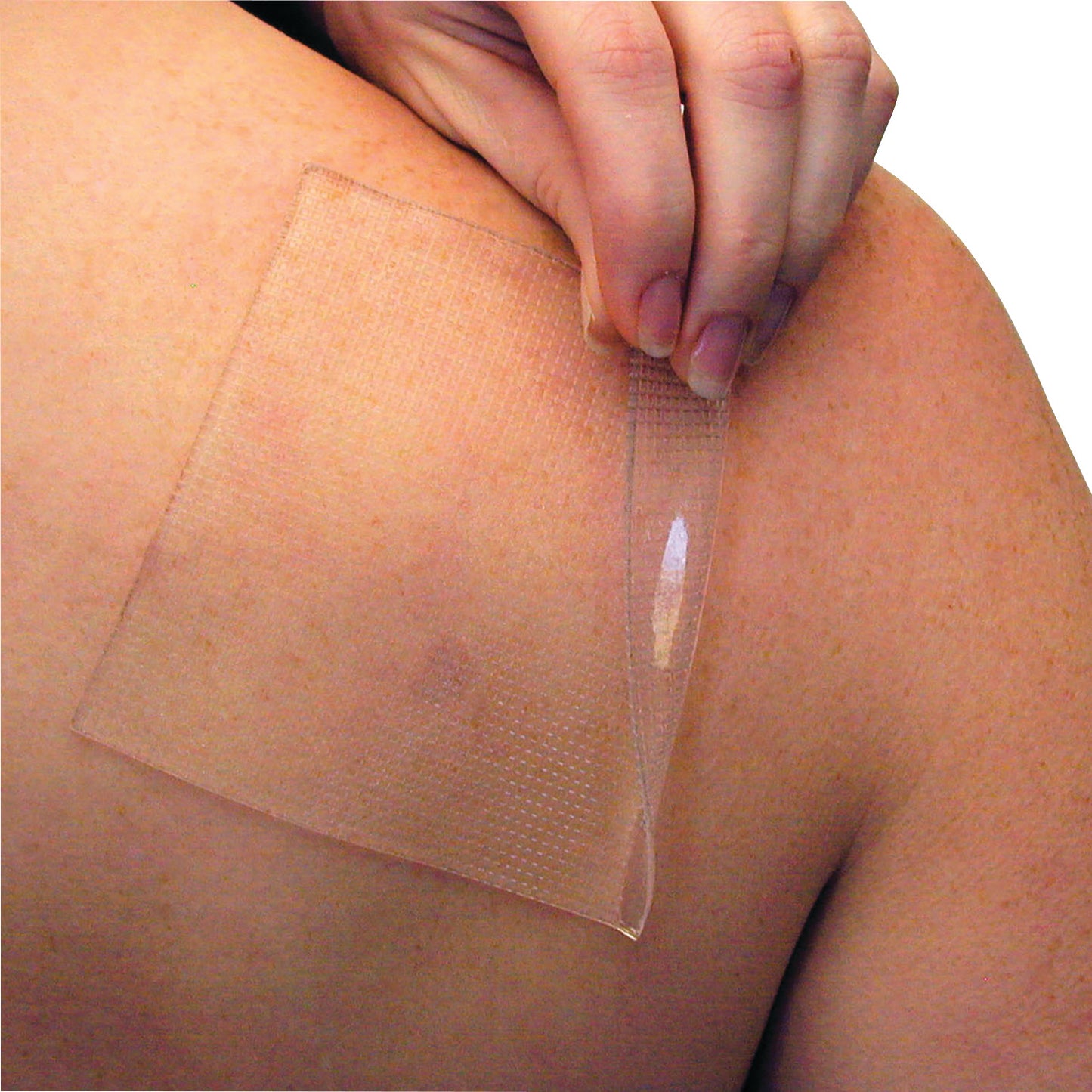 A person applying a PediFix Visco-GEL Self-Adhesive Gel Sheeting on their shoulder, showing the product's transparent texture.