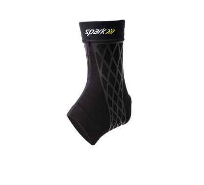 The image shows a Brownmed Spark Kinetic Ankle Sleeve, a black support sleeve with a diamond-patterned design on its side.