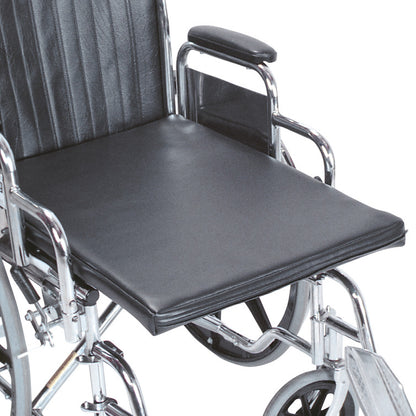 AliMed Amputee Wheelchair Surface on a wheelchair, featuring a black cushion with a smooth finish and chrome frame.