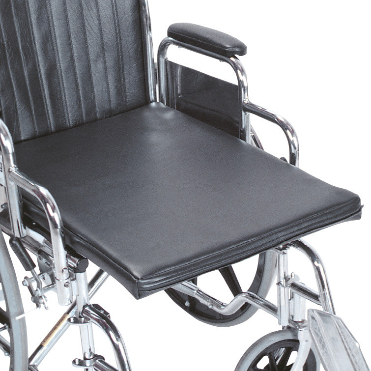 The image shows the AliMed Amputee Wheelchair Surface, a black cushioned seat designed for comfort on a wheelchair.