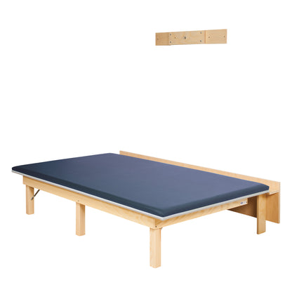 Clinton Wall-Mounted Upholstered Mat Platform with a blue padded surface, wood frame, and attached headboard, shown with a wall bracket.