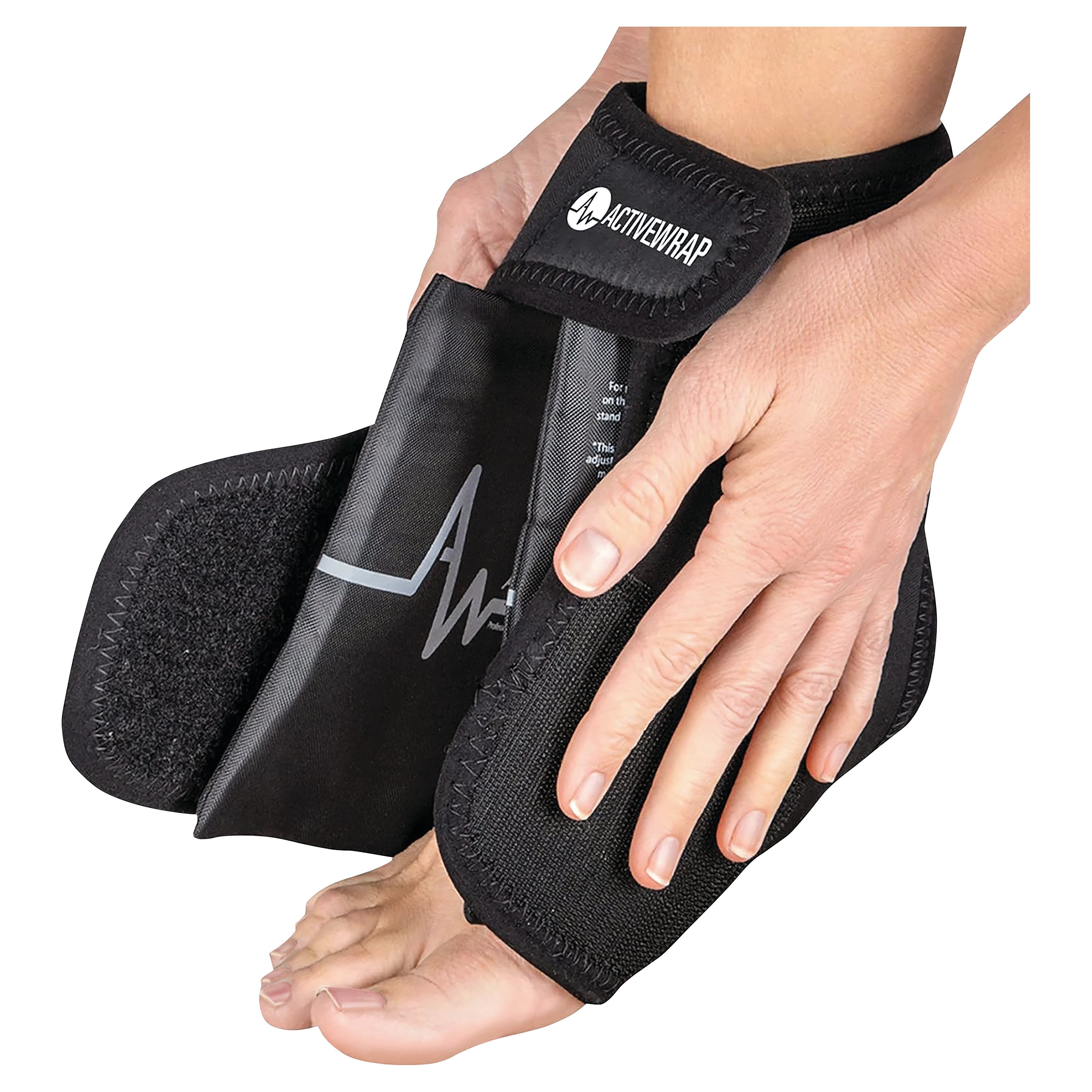 Hands are adjusting an ActiveWrap ankle support around a foot. The wrap is black with a strap.