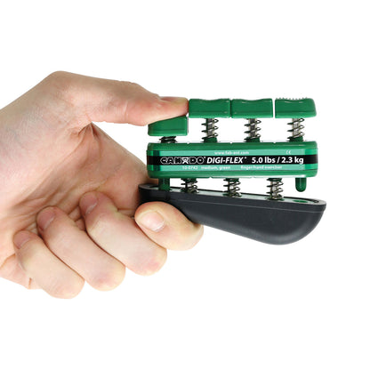 Hand holding a CanDo Digi-Flex Hand Exerciser, medium green, labeled 5.0 lbs/2.3 kg, used for finger and hand exercises.