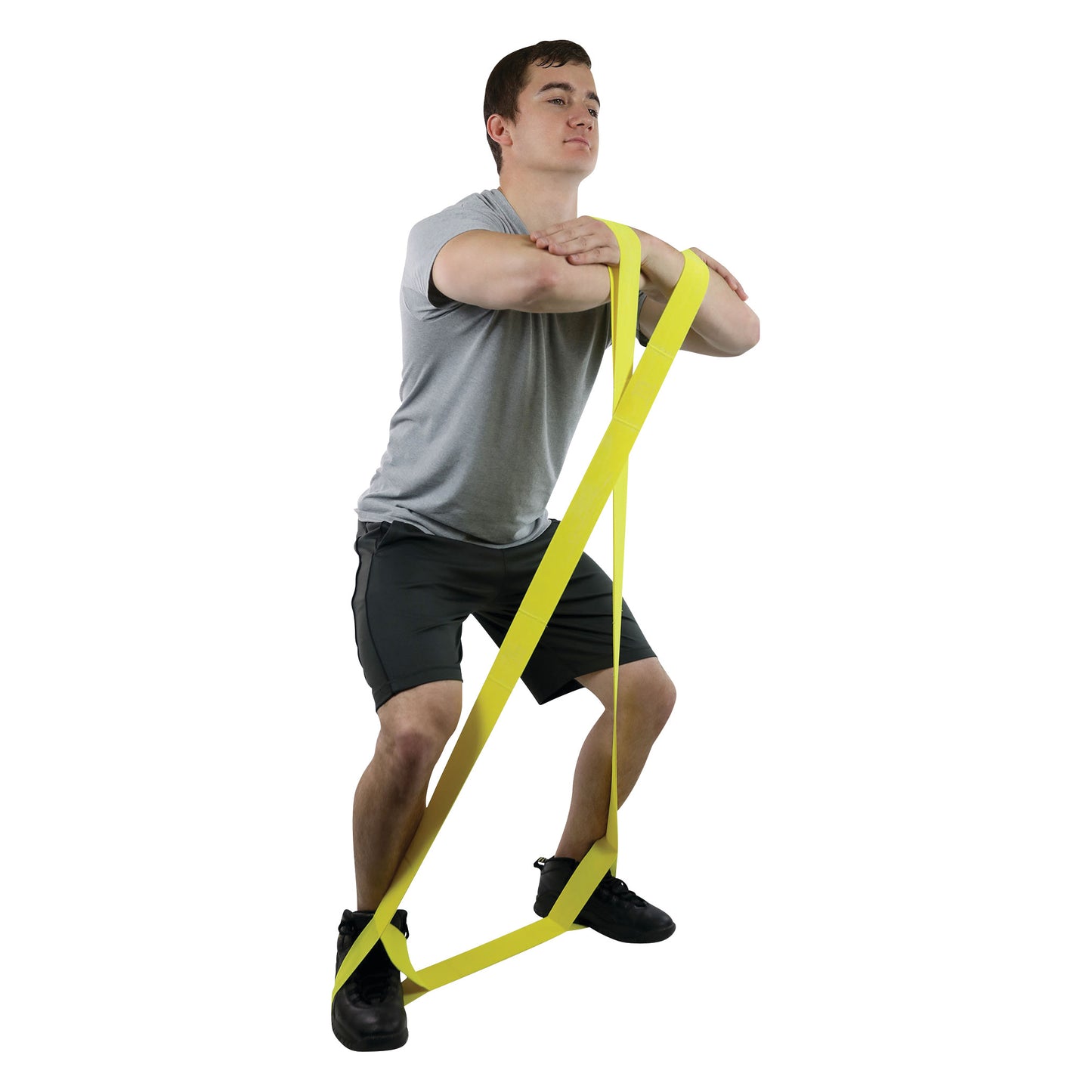 A person uses the CanDo Multi-Grip Exerciser in a squat position, wearing a gray shirt and black shorts.