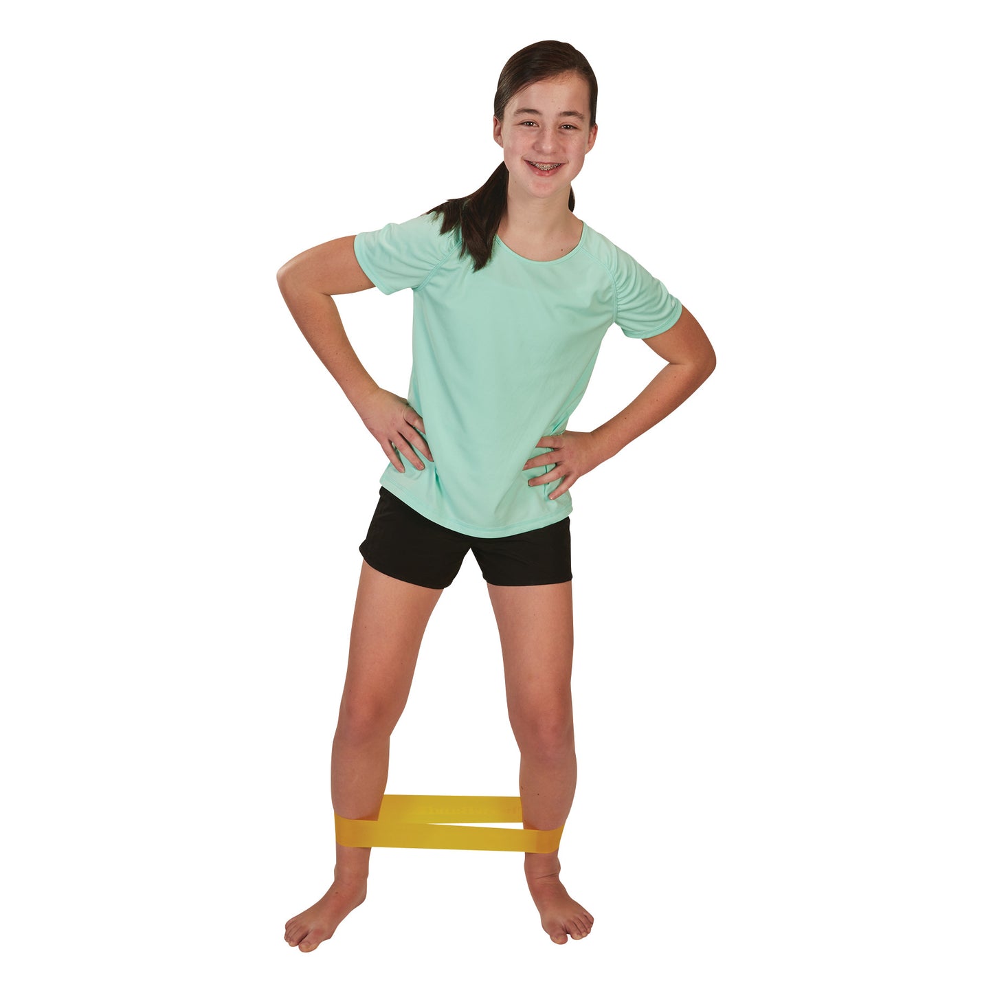 A girl in a turquoise shirt and black shorts exercises with a yellow CanDo Band Exercise Loop around her legs.