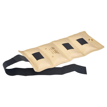 AliMed Color-Coded Cuff Weight in beige with three black fasteners, featuring an adjustable strap and a brass grommet on one end.