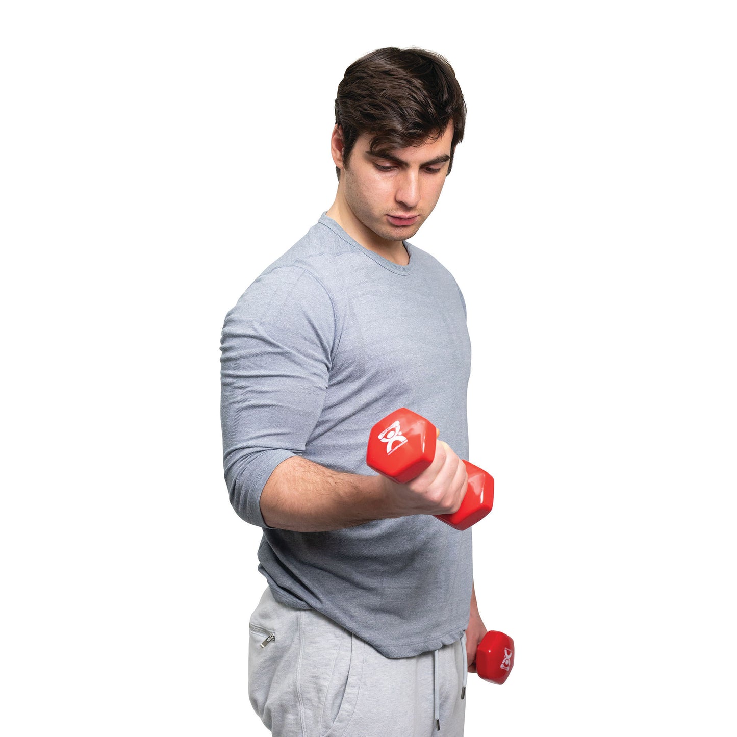 A person in a gray shirt lifts a red CanDo Vinyl-Coated Dumbbell, with another dumbbell in their other hand, against a white background.