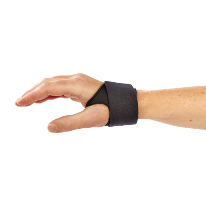 A hand wears the AliMed FREEDOM AliDry CMC ThumbFit Support, a black adjustable strap designed for thumb and wrist support.