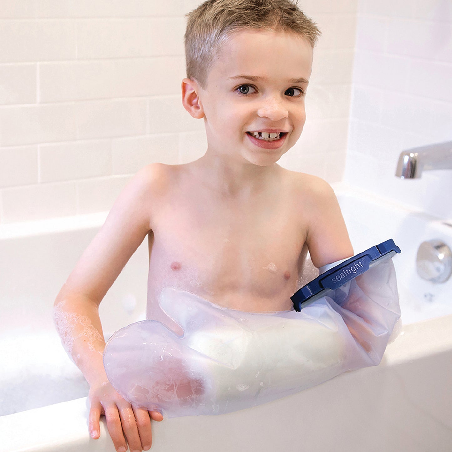 A child bathes using the Brownmed SEAL-TIGHT Infinity Cast Protector on their arm, keeping it dry and protected.