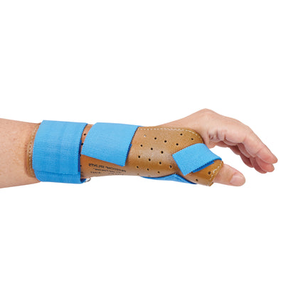 A hand wearing the AliMed FREEDOM Thumb Spica, a brown perforated brace with blue straps, supporting the wrist and thumb.