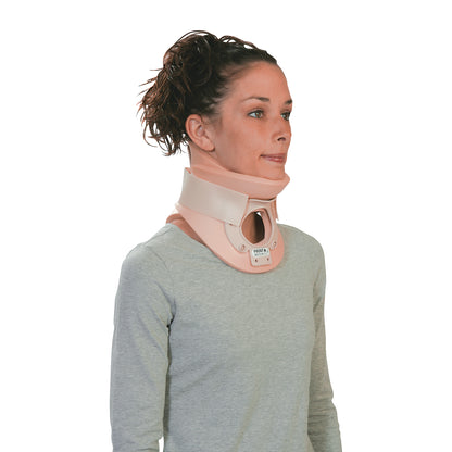 A person wearing an Ossur Philadelphia Tracheotomy Collar, designed for neck support, over a light grey long-sleeve shirt.