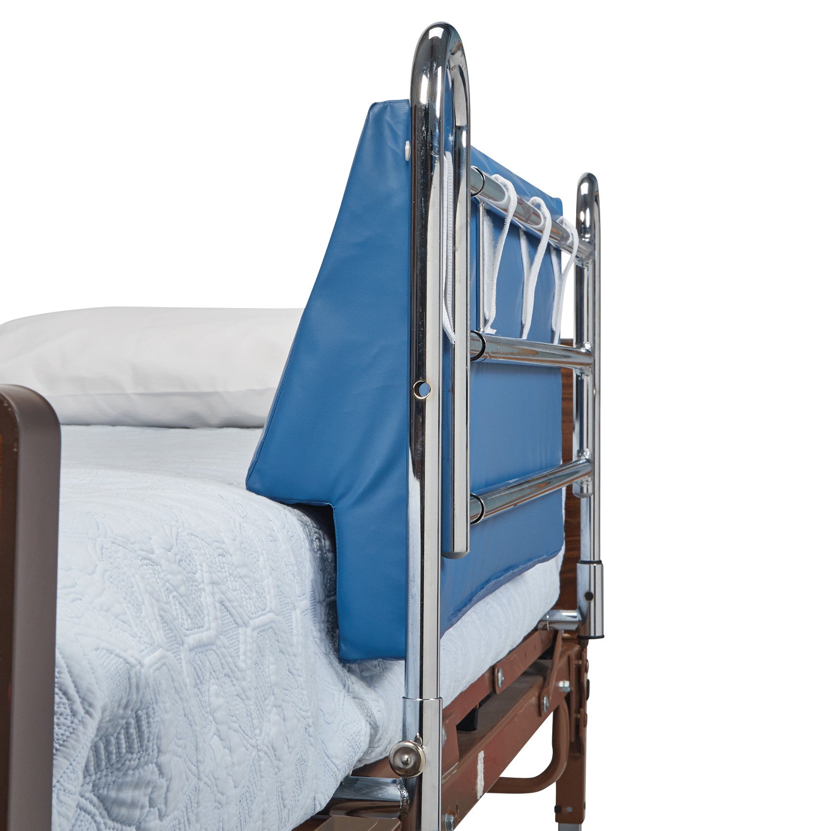 A hospital bed with a metal side rail and an AliMed Upholstered Foam Bed Bolster covered in blue material alongside the mattress.