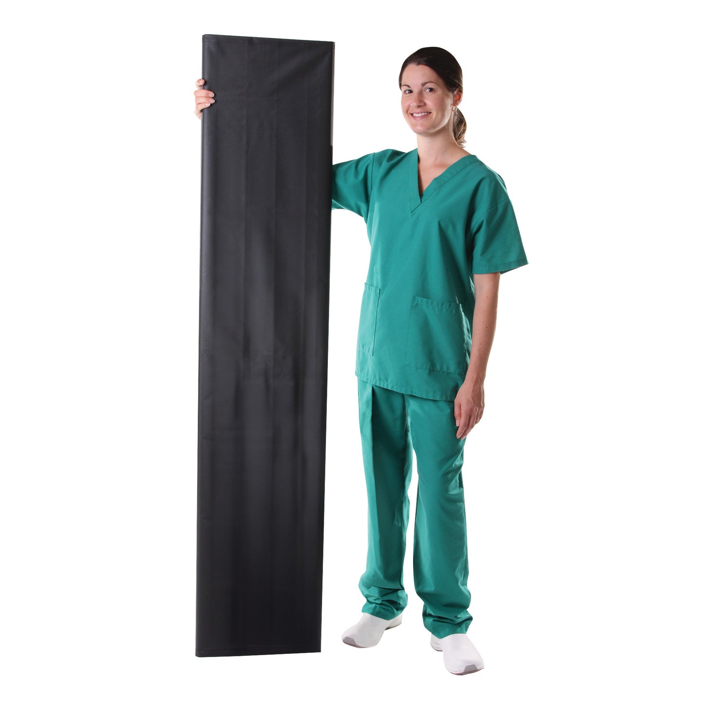 A person in green scrubs holds up the AliMed Patient Roller and Rack Kit, a black rectangular pad, standing vertically.