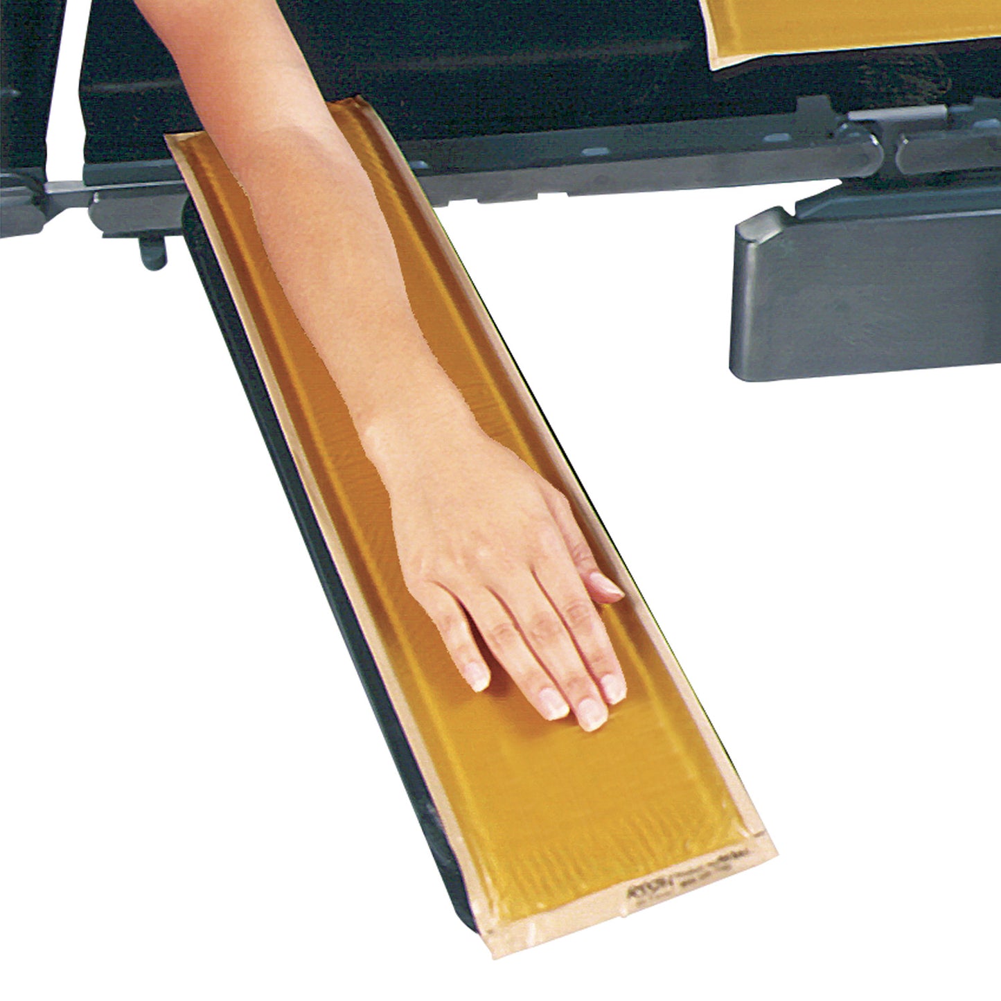 A person rests their arm on an AliMed AliGel Standard Armboard Pad, which is a brown gel pad used for support.