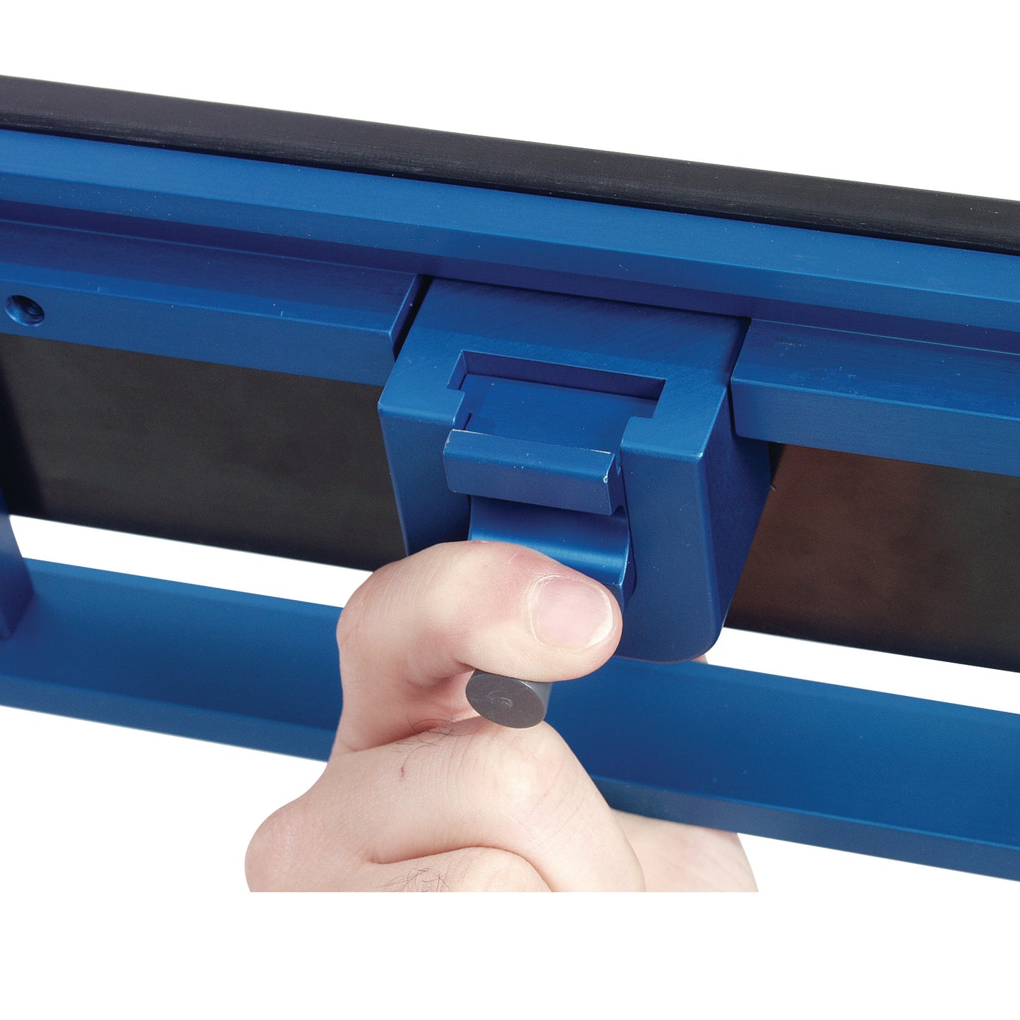 A hand adjusts the AliMed FREEDOM O.R. Table Width Extender with Pad, showing its blue hinge mechanism close up.