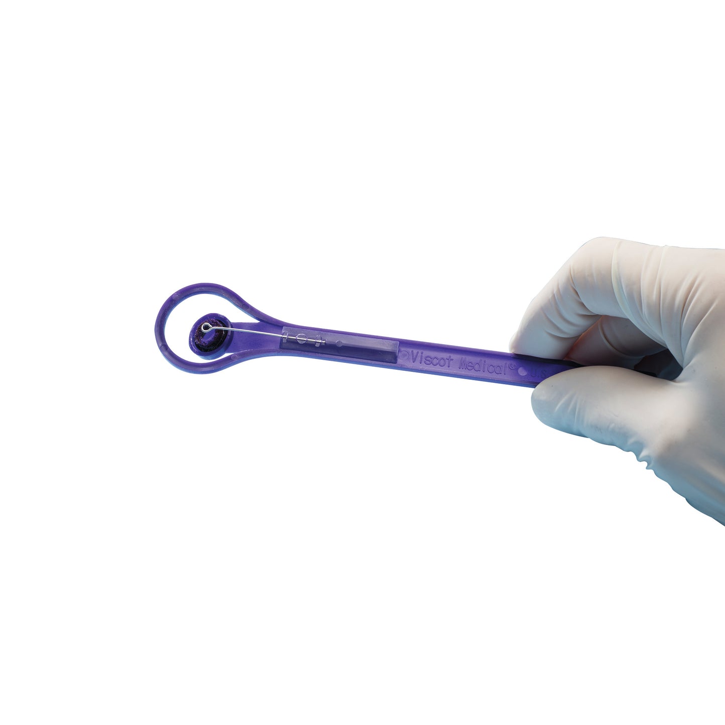 A gloved hand holds a Viscot Accumark Radiopaque Injection Site Marker, which is purple with a circular tip.