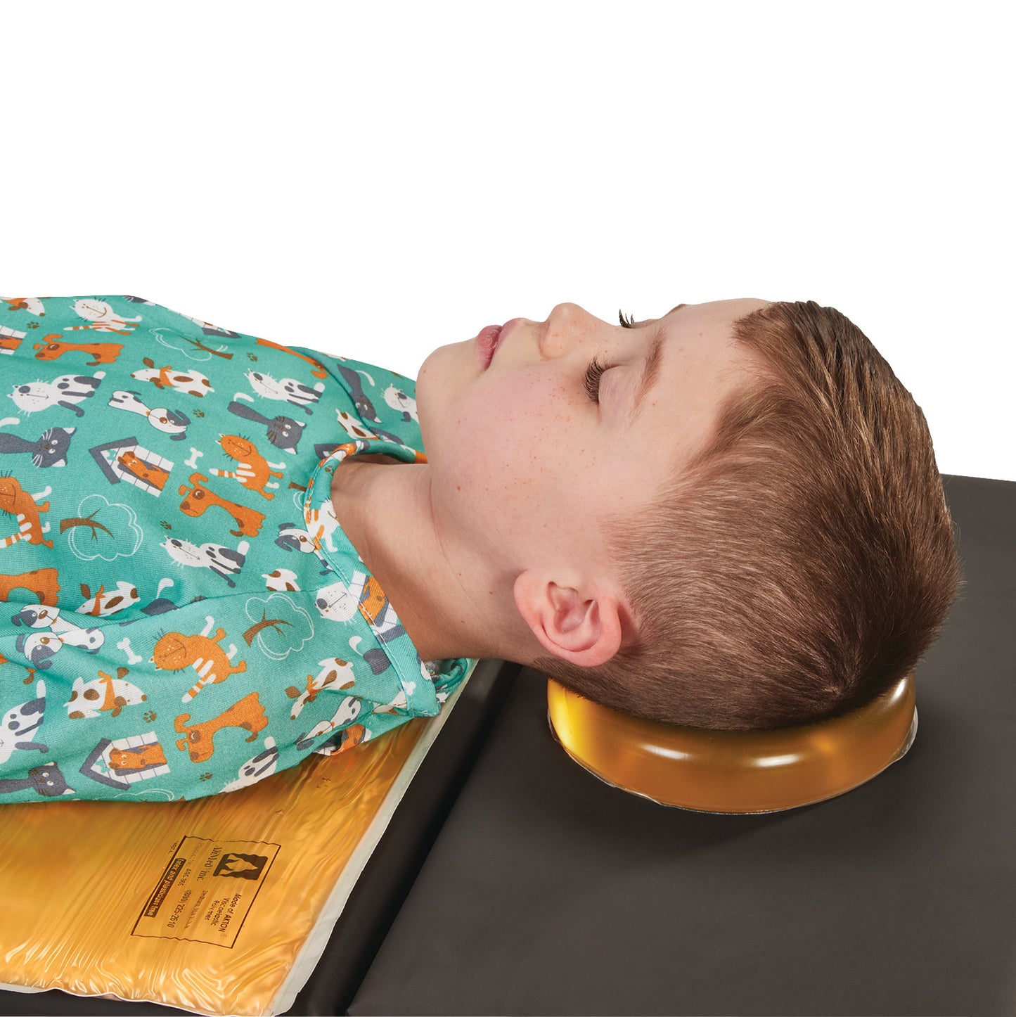 A child rests their head on the AliMed AliGel Head Donut, designed for comfort. The child wears a shirt with an animal pattern.
