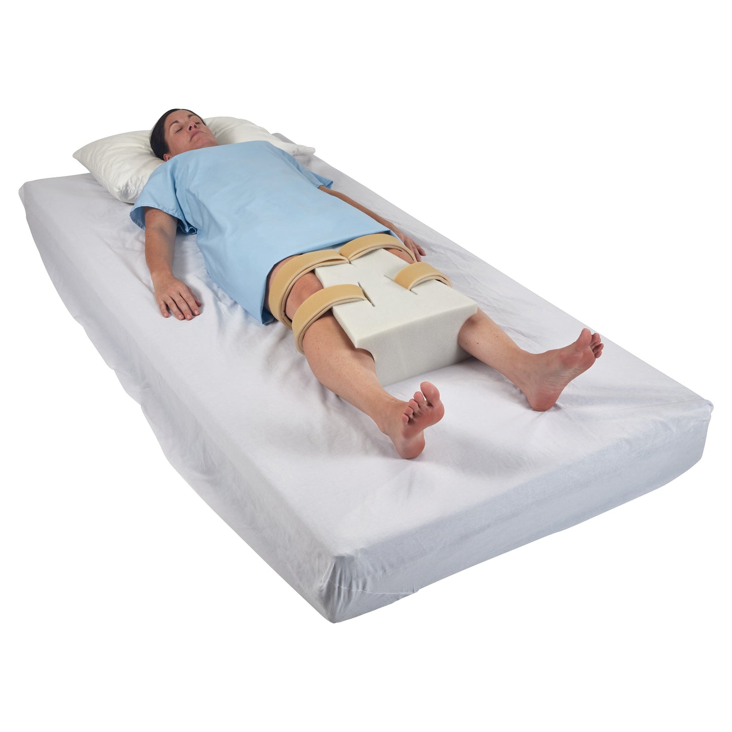 A person lies on a bed with an AliMed Abduction Pillow between their legs, secured by straps, wearing a blue garment.