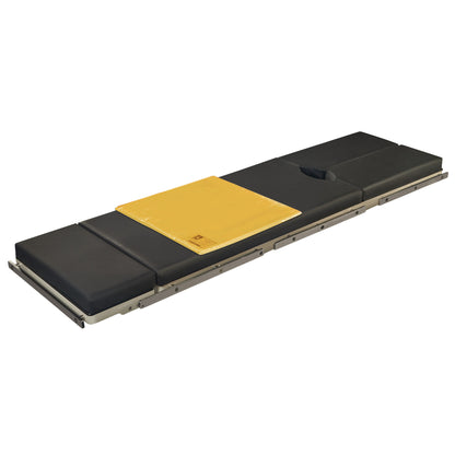 A black, padded patient stretcher with an Action Surface Overlay on top, featuring a yellow section and a headrest cutout.