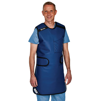 A person wearing an AliMed Grab n Go Flex Weight Reliever Apron, Male, over light blue scrubs, standing and smiling.