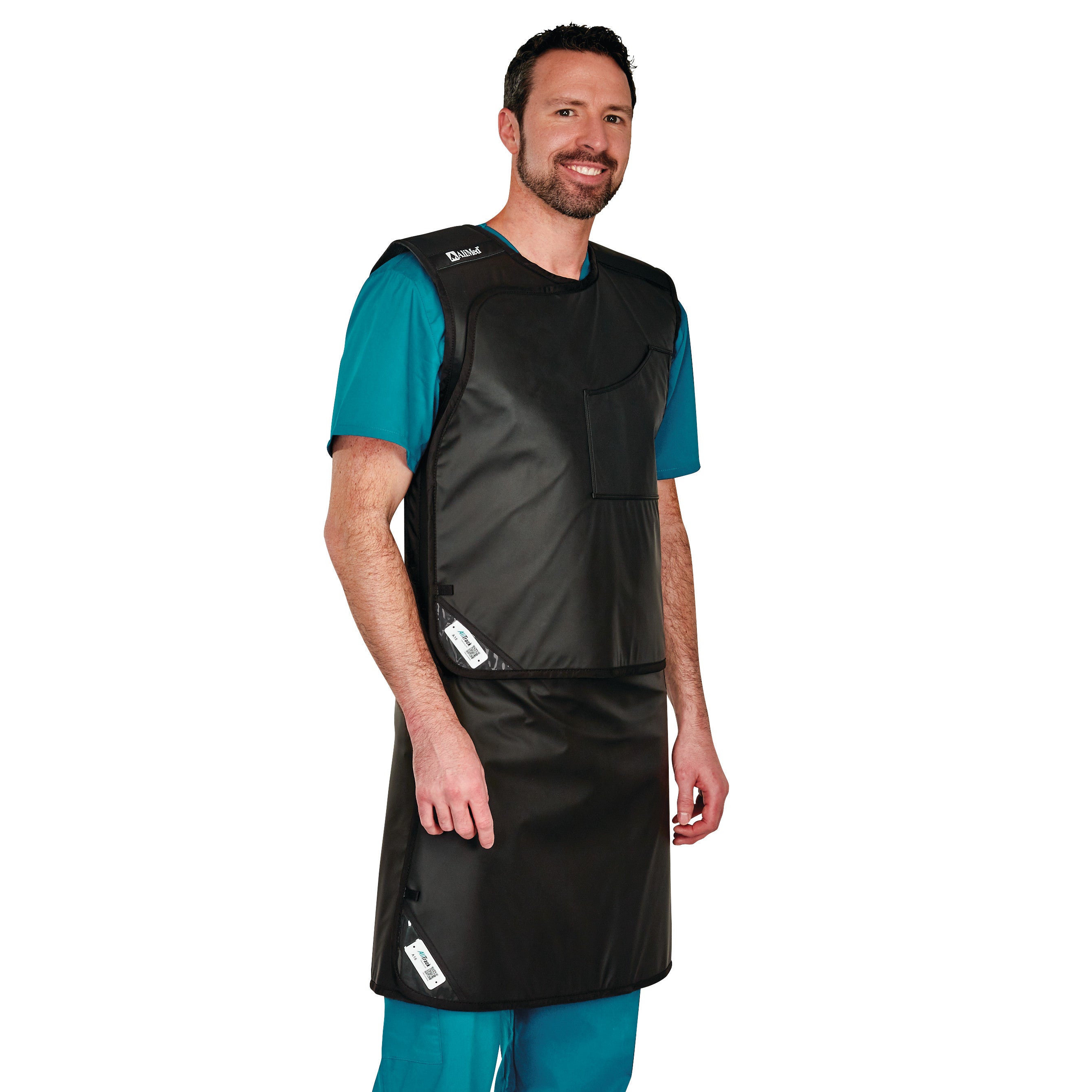 A man wears the AliMed Grab n Go Vest and Kilt Set, Male. The set is black, worn over teal scrubs.