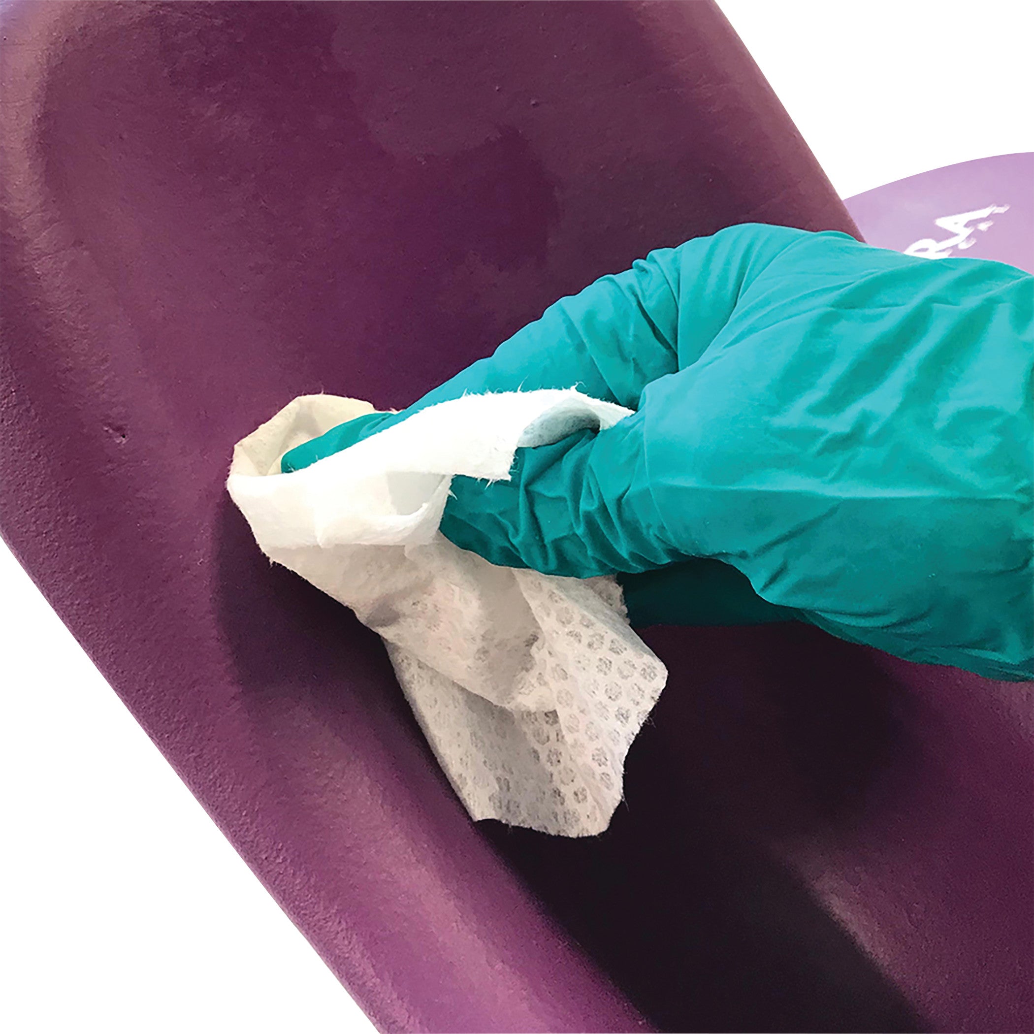 A gloved hand wipes a KYRA Clean 500 Lithotomy Stirrup with a white cleaning cloth. The stirrup is purple.