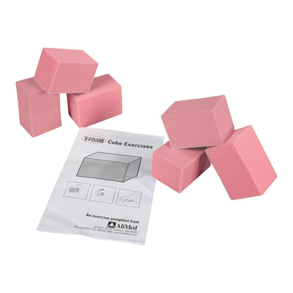 Pink AliMed T-Foam Visco Cubes are arranged next to an exercise pamphlet titled "Cube Exercises" from AliMed.