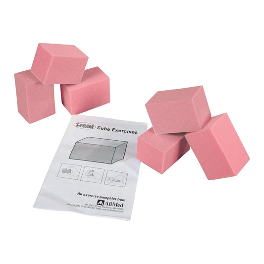 Pink AliMed T-Foam Visco Cubes are arranged next to an exercise pamphlet titled "Cube Exercises" from AliMed.