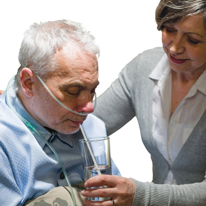 Nurse helping senior sick man with drinking glass of water