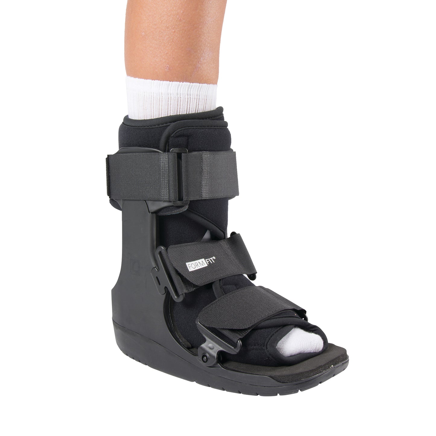 A leg wearing an Ossur Formfit Low-Top Walker with black straps and a white sock, designed for foot and ankle support.