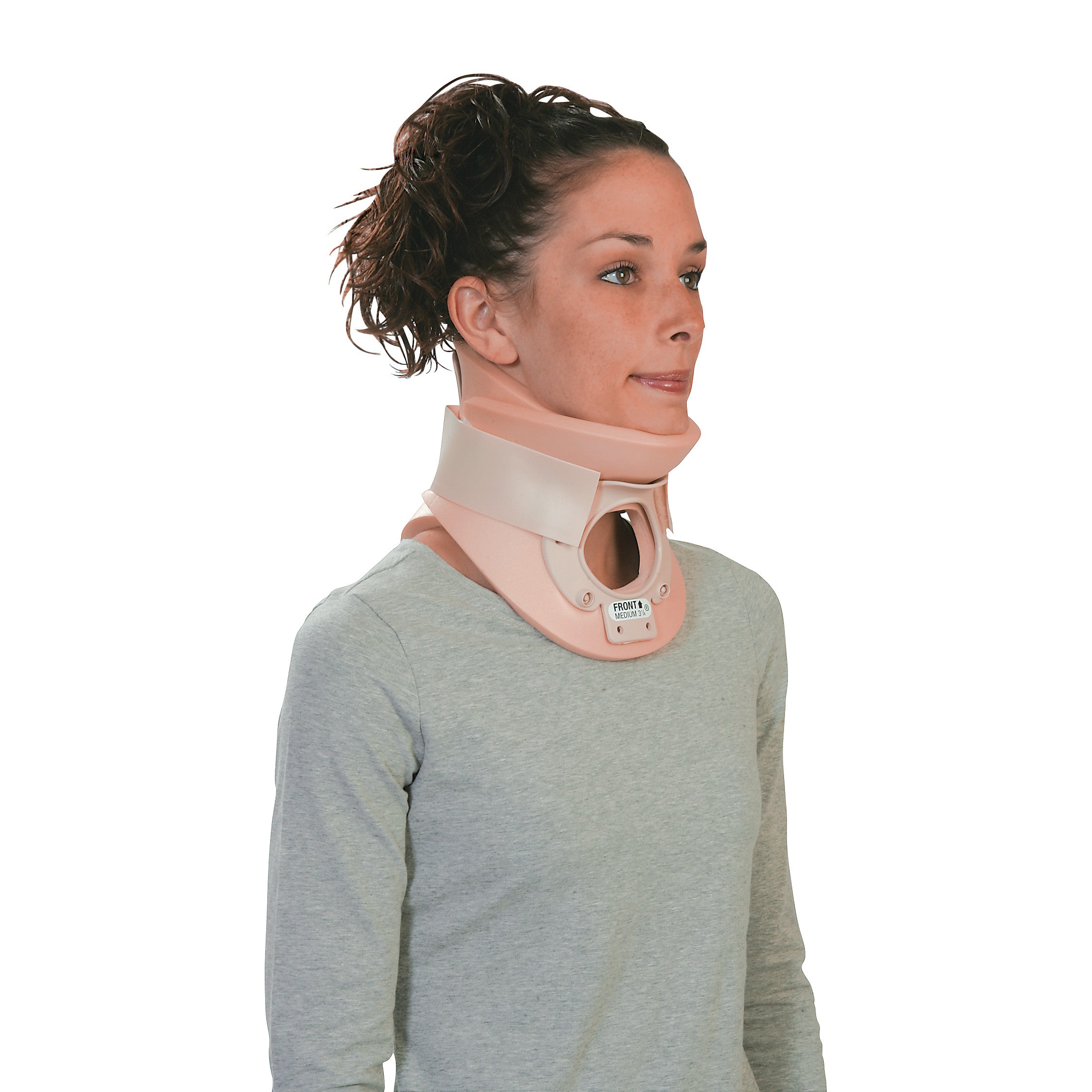 A person wears an Ossur Philadelphia Tracheotomy Collar, a beige neck support device, over a light gray shirt.
