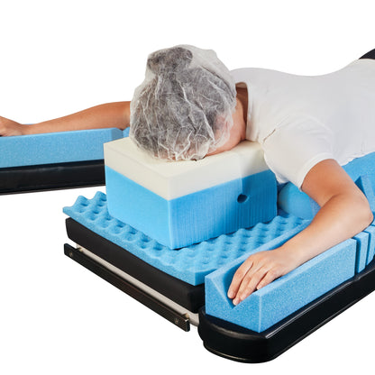 Person using the AliMed AliSoft Head Positioner, made of blue and white foam, lying face down with a head cover.