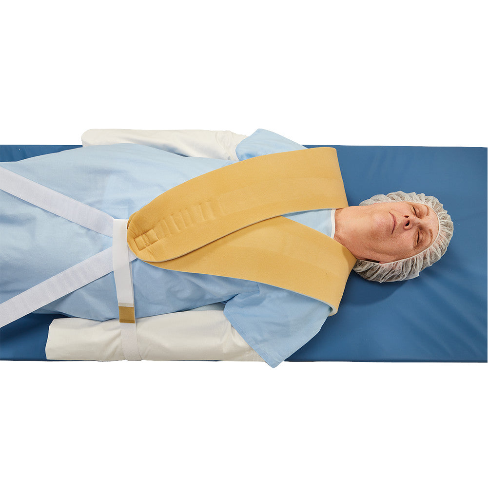 A person lies on a blue mat wearing an AliMed Cervical Visualization Harness, used for medical positioning.