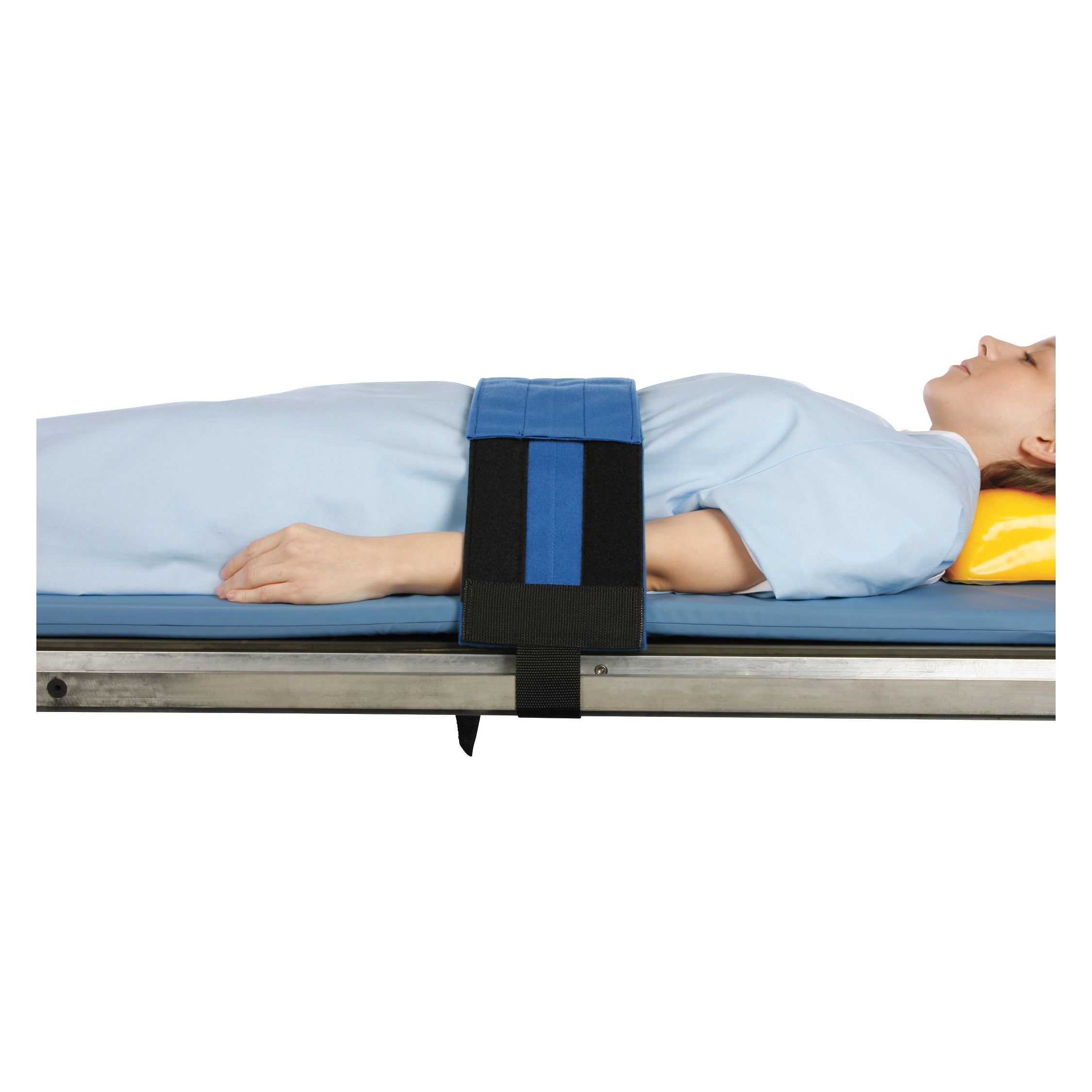 A person lies on a stretcher wearing the AliMed Cath Lab Immobilizer, a blue and black strap securing them to the bed.