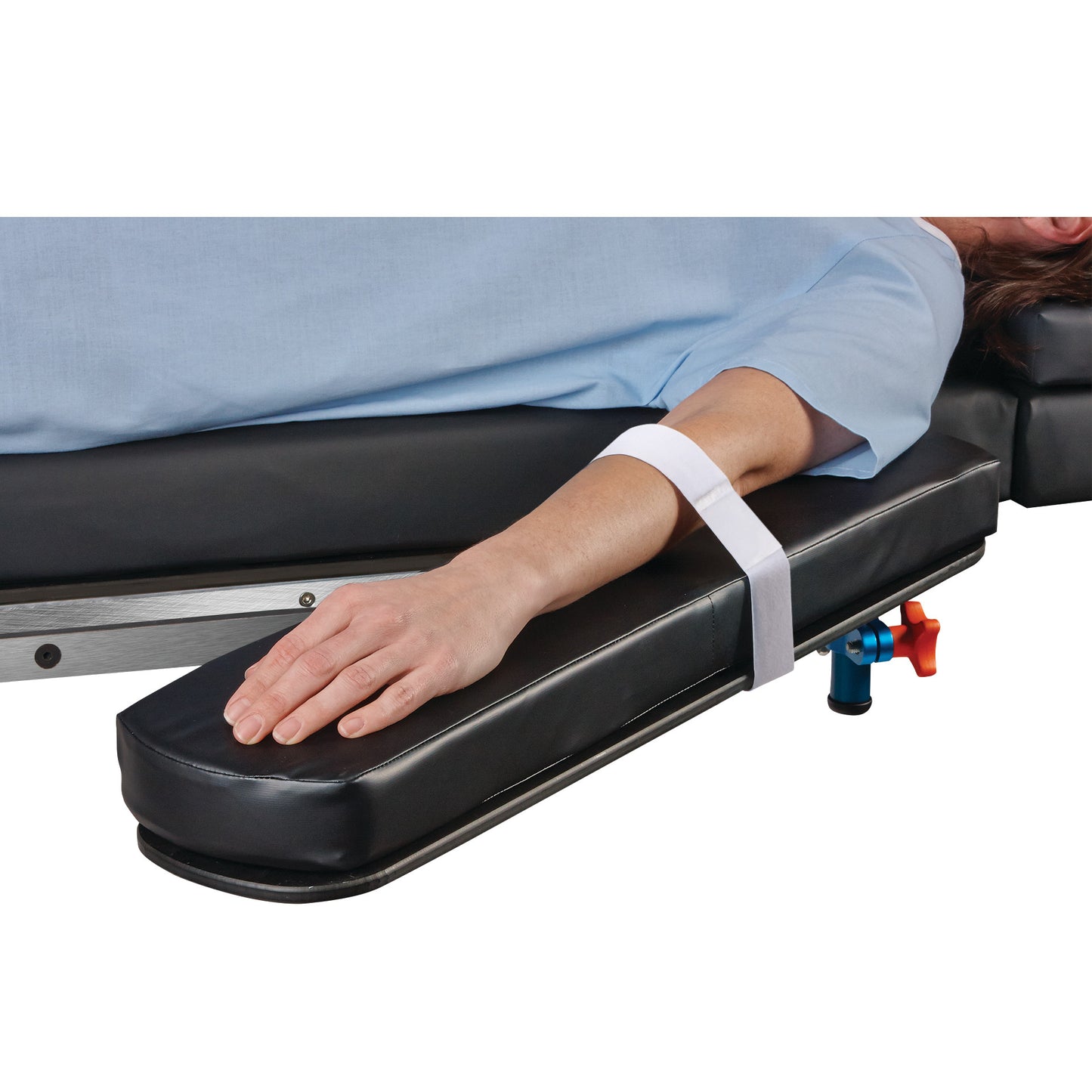 A person's arm is strapped to a padded armboard using the AliMed Soft-Touch Armboard Strap, which is white and adjustable.