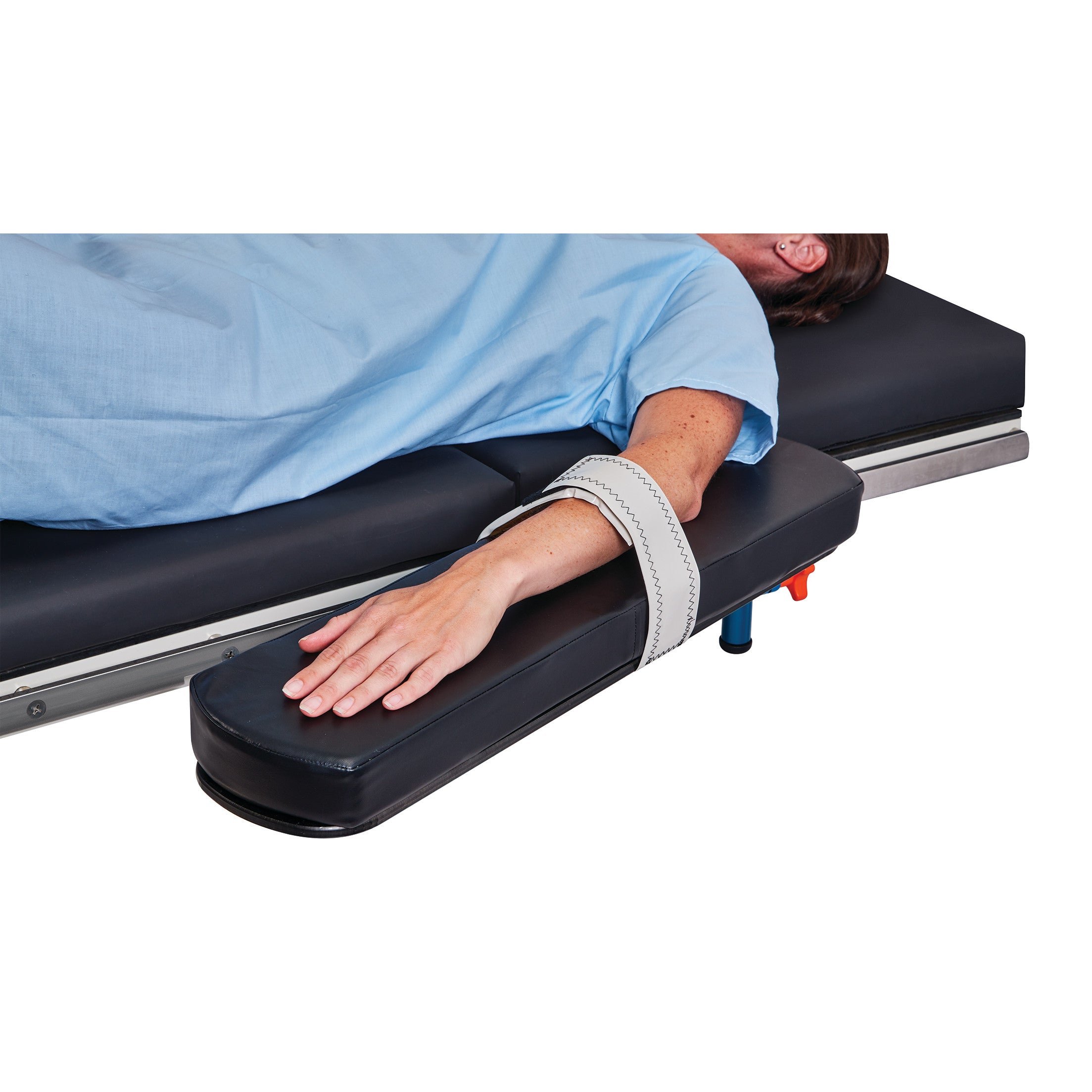 A person lies on a medical bed with their arm secured on an armrest using the Action Gel Arm/Hand Stabilizer Strap.