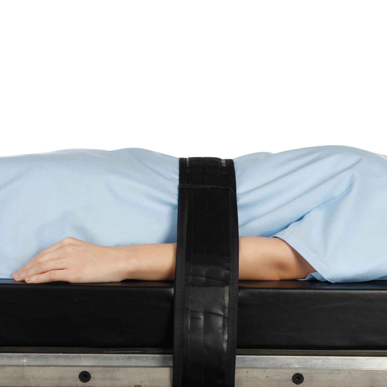 Person lying on a table with an AliMed Nonmetallic Operating Room Table Strap securing them across the torso.