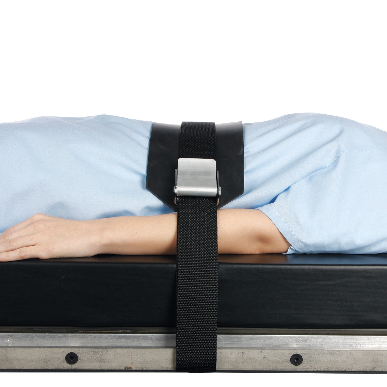 Person lying on a surface secured with AliMed Basic Mid-Panel Straps, featuring a black strap and a silver buckle over the torso.