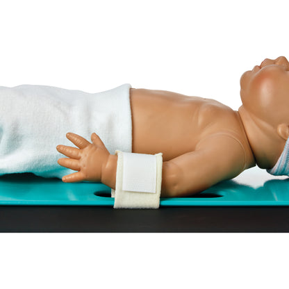 A baby mannequin on its side with an Arista Baby Board Strap around its wrist, demonstrating proper restraint use on a blue board.