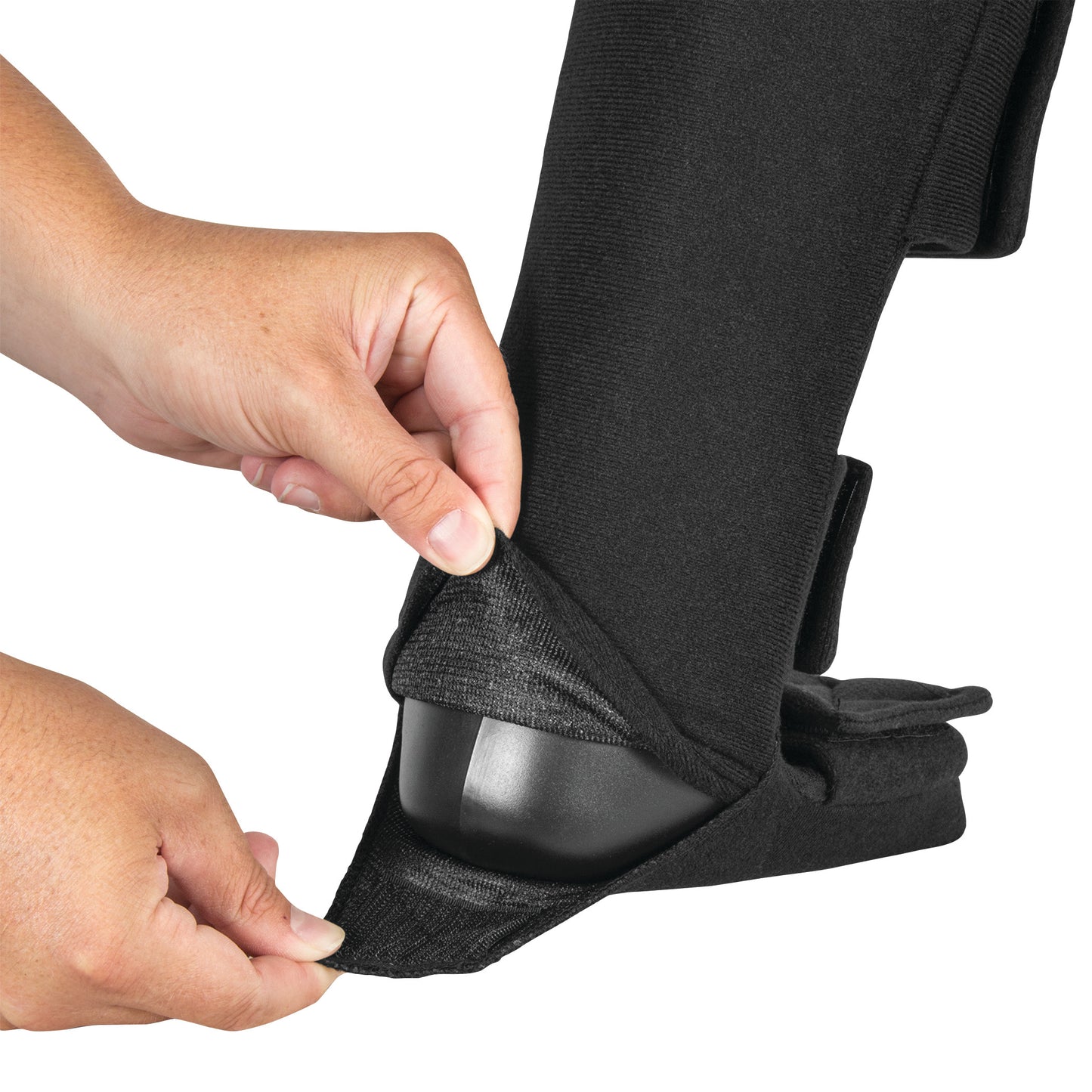Hands adjusting a black DARCO Night Splint Wedge, revealing its rigid inner support structure.